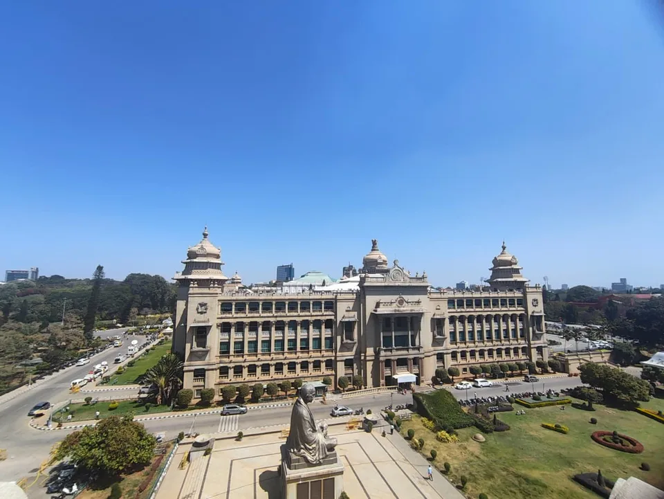 The Vidhana Soudha in Bengaluru seen from an elevated viewpoint in daylight, its domed facade and colonnade in full view.